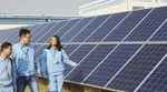 Unilever employees walking next to solar panels.